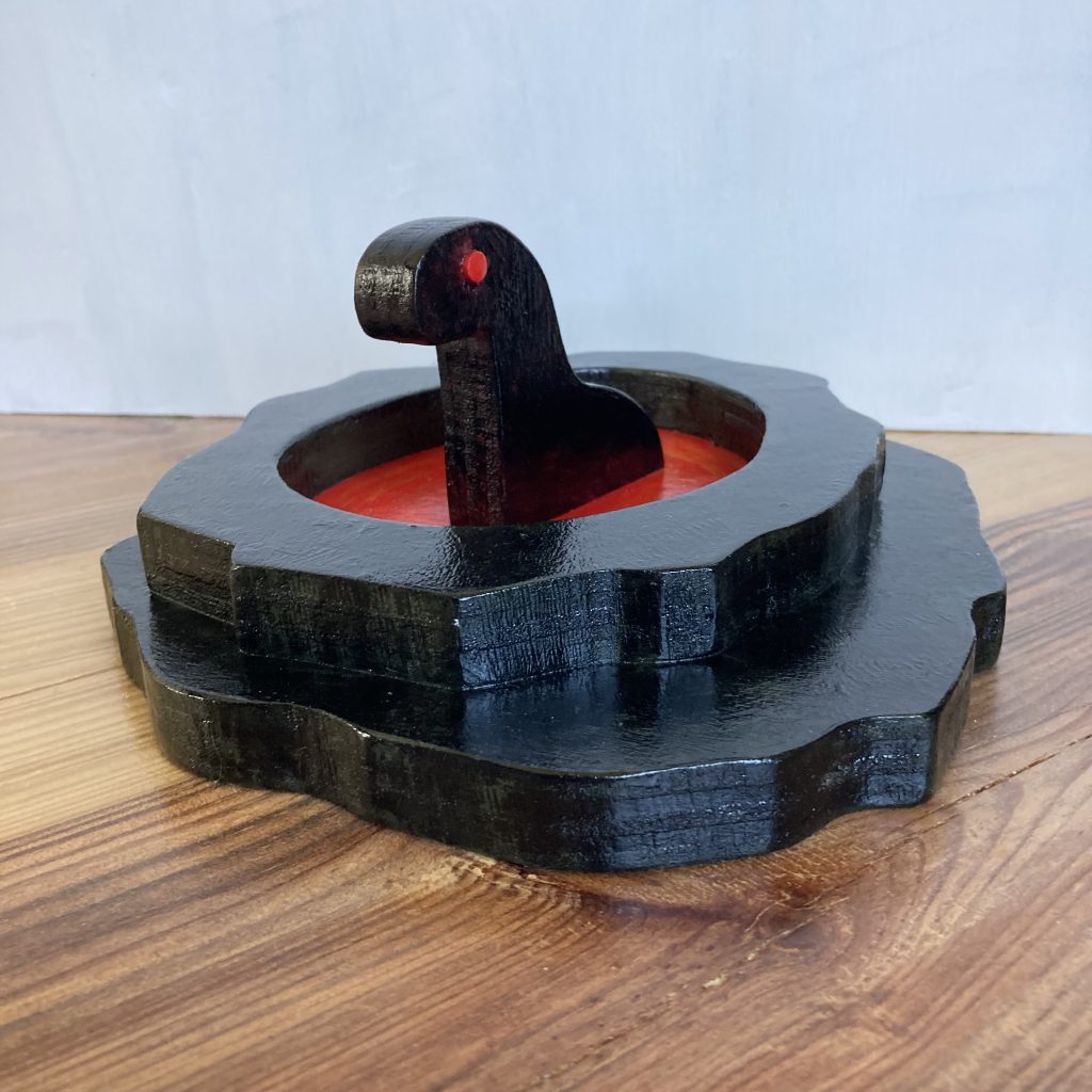 painted wooden sculpture of a creature sitting in a pool