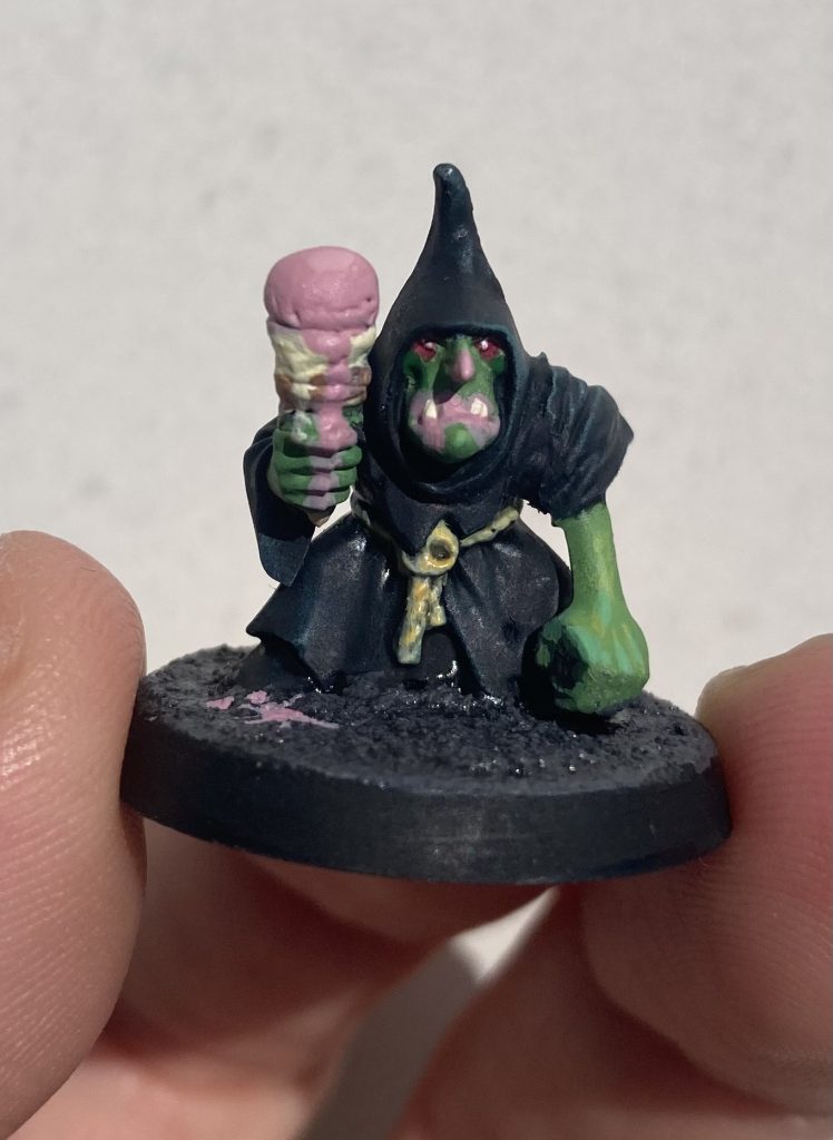 a Warhammer goblin miniature eating an ice cream cone